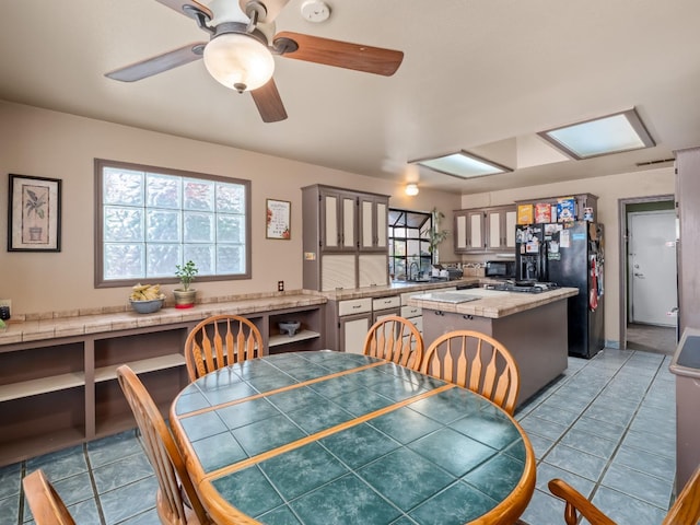 dining room featuring light tile patterned flooring and ceiling fan