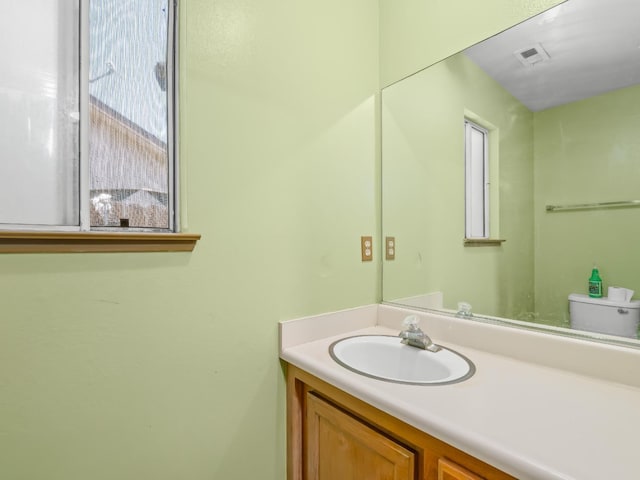 bathroom with vanity and toilet