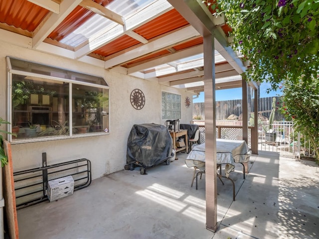 view of patio / terrace with fence, a grill, and outdoor dining space