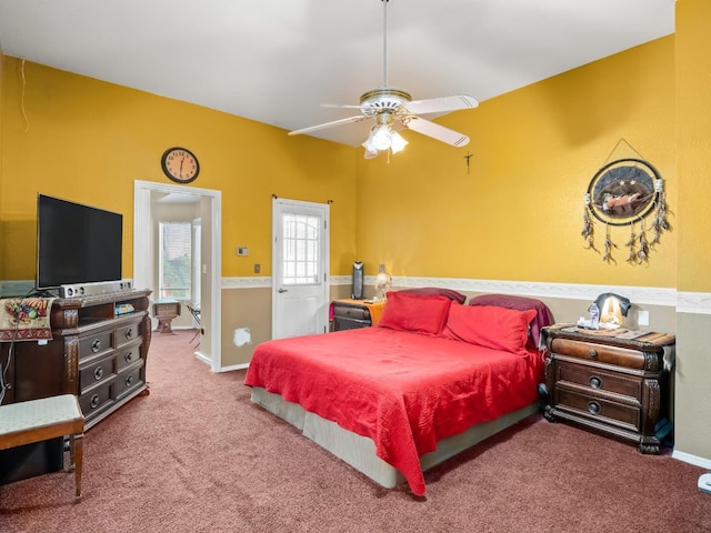 carpeted bedroom with ceiling fan and baseboards