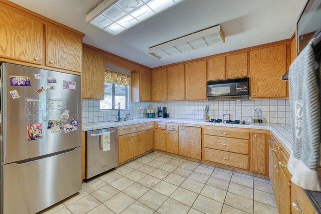 28302 Tollhouse Rd, Tollhouse, CA 93667 - kitchen featuring appliances with stainless steel finishes, a sink, decorative backsplash, tile counters, and brown cabinets