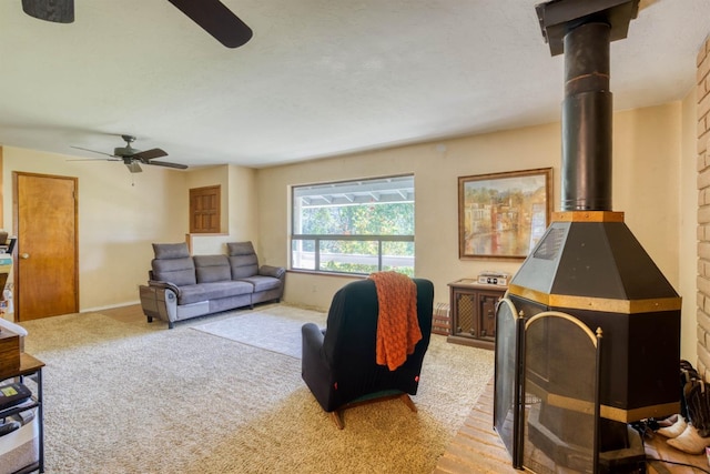 28302 Tollhouse Rd, Tollhouse, CA 93667 - carpeted living area featuring ceiling fan, a wood stove, and baseboards