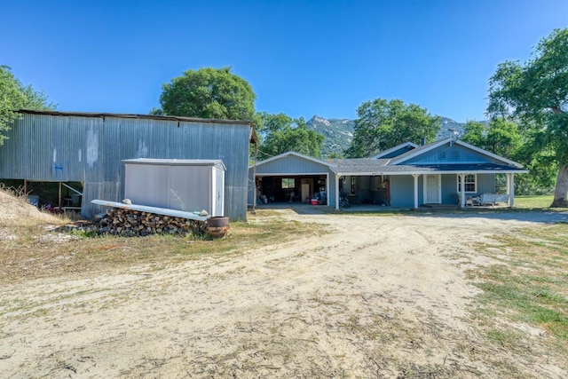 28302 Tollhouse Rd, Tollhouse, CA 93667 - view of front of home with an outbuilding, an outdoor structure, a garage, and covered porch