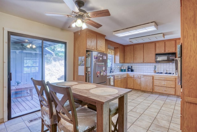 28302 Tollhouse Rd, Tollhouse, CA 93667 - kitchen with stainless steel appliances, tasteful backsplash, light tile patterned flooring, a ceiling fan, and tile countertops