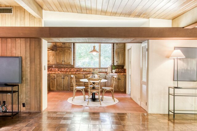 dining area featuring beam ceiling and wood ceiling