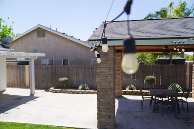 fenced backyard with a patio, outdoor dining space, a gazebo, and a pergola