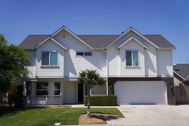 view of front of property with concrete driveway, an attached garage, and covered porch