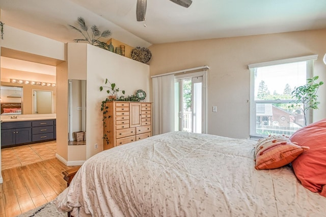 bedroom featuring access to exterior, ensuite bath, light wood-style floors, vaulted ceiling, and ceiling fan