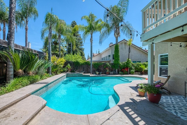 view of swimming pool featuring a fenced backyard and a patio area