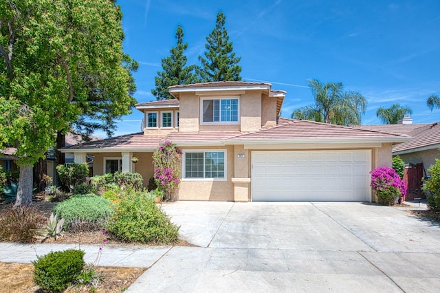 view of front facade featuring stucco siding, driveway, a tile roof, and a garage