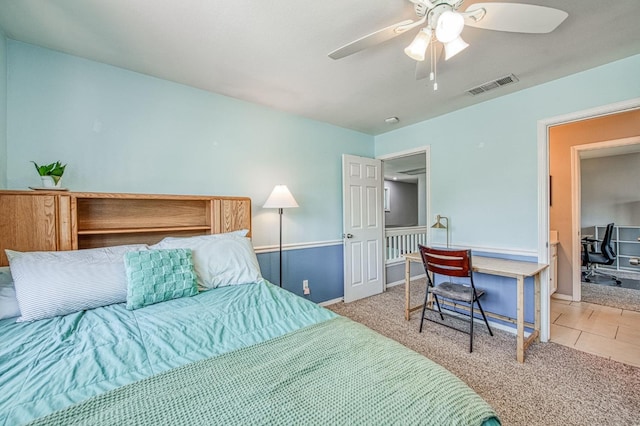 bedroom with an office area, carpet, baseboards, and ceiling fan