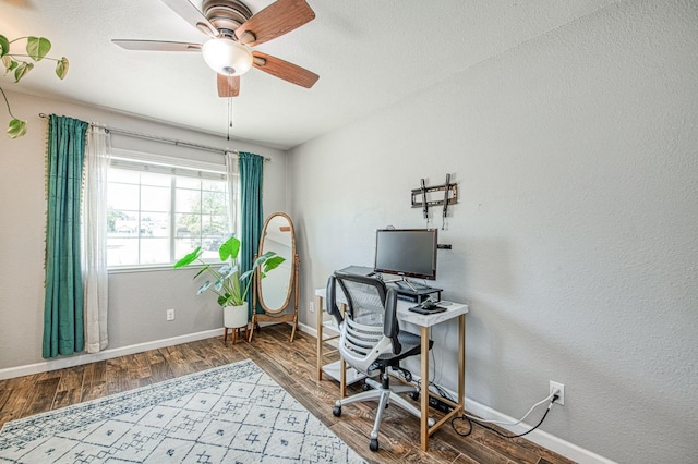 office space featuring ceiling fan, wood finished floors, and baseboards