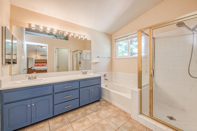 ensuite bathroom featuring vaulted ceiling, tile patterned flooring, a stall shower, a garden tub, and double vanity