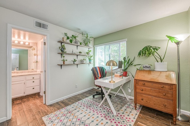 home office with wood finished floors and baseboards