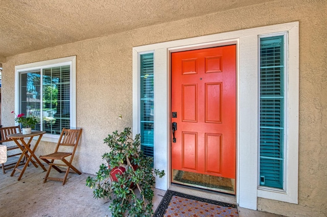 property entrance with stucco siding