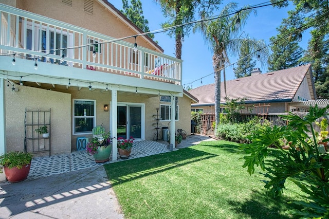 back of property featuring stucco siding, a deck, and a patio area