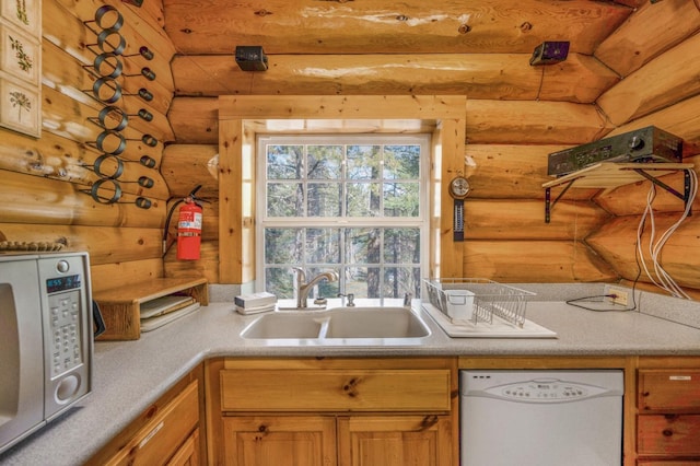 55585 Flintridge Dr, Shaver Lake, CA 93664 - kitchen with white dishwasher, rustic walls, stainless steel microwave, a sink, and light countertops
