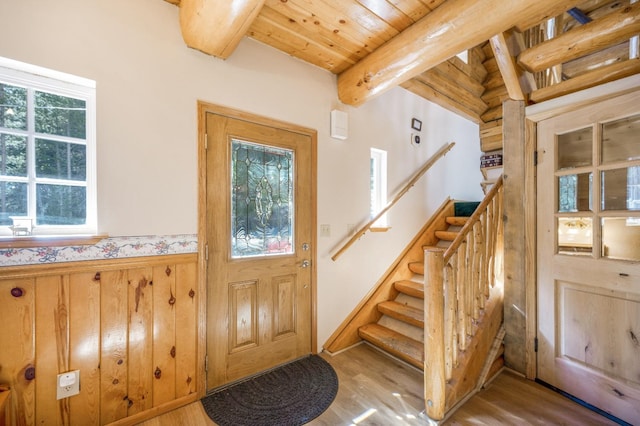 55585 Flintridge Dr, Shaver Lake, CA 93664 - entryway featuring wood finished floors, beam ceiling, wood ceiling, a wainscoted wall, and stairway