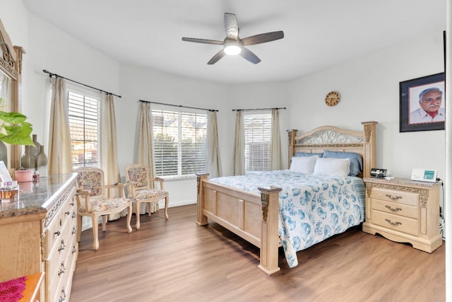 bedroom with light wood-style floors and a ceiling fan