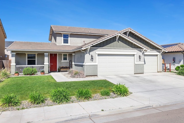 view of front of house with an attached garage, a porch, stucco siding, a front yard, and concrete driveway