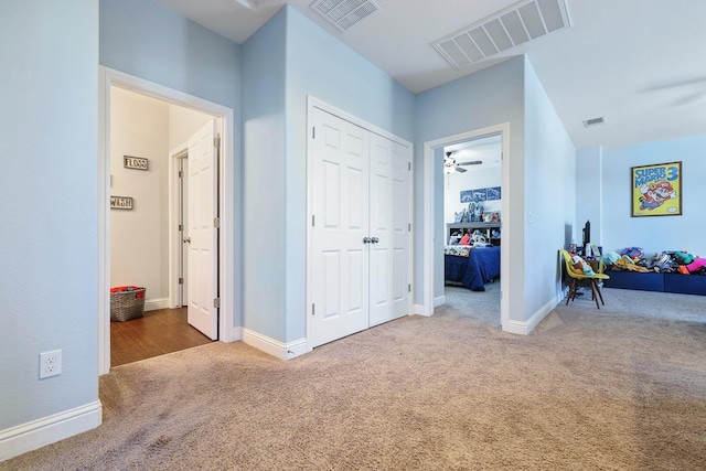 hallway with carpet flooring and baseboards