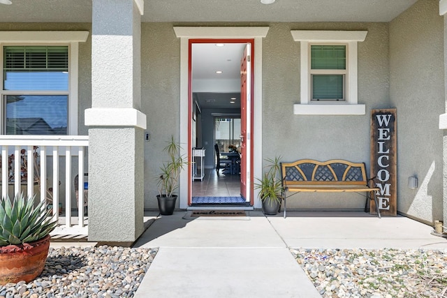 entrance to property featuring stucco siding