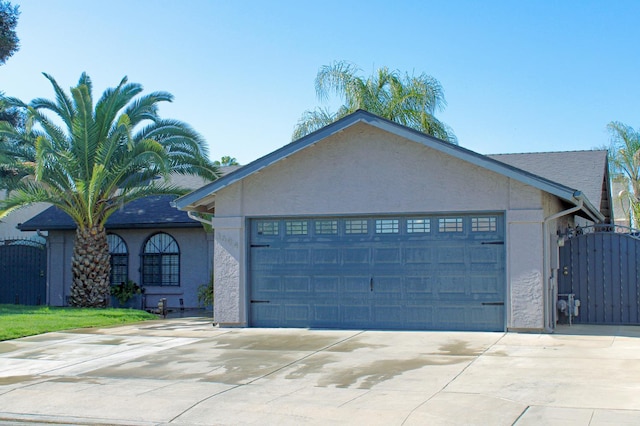3694 W Robinson Ave, Fresno, CA 93722 - single story home featuring concrete driveway, an attached garage, stucco siding, and a gate