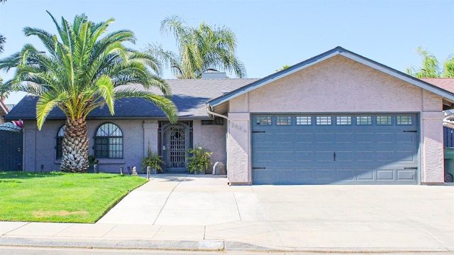 ranch-style home featuring stucco siding, an attached garage, concrete driveway, and a front lawn