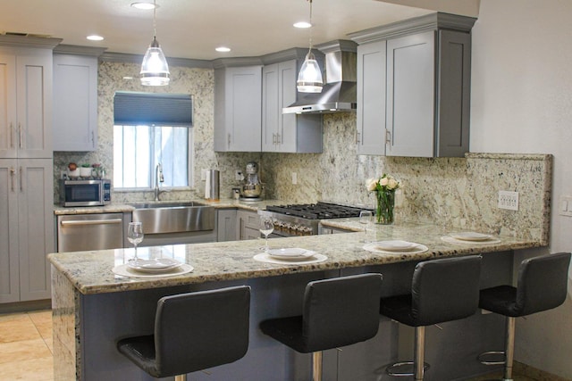 3694 W Robinson Ave, Fresno, CA 93722 - kitchen with wall chimney exhaust hood, stainless steel appliances, gray cabinets, a peninsula, and tasteful backsplash