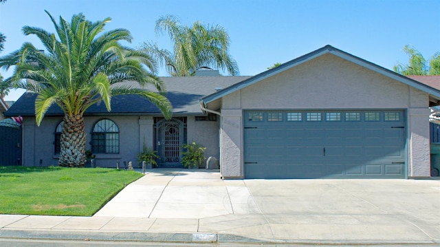 3694 W Robinson Ave, Fresno, CA 93722 - ranch-style home featuring stucco siding, a garage, concrete driveway, and a front lawn