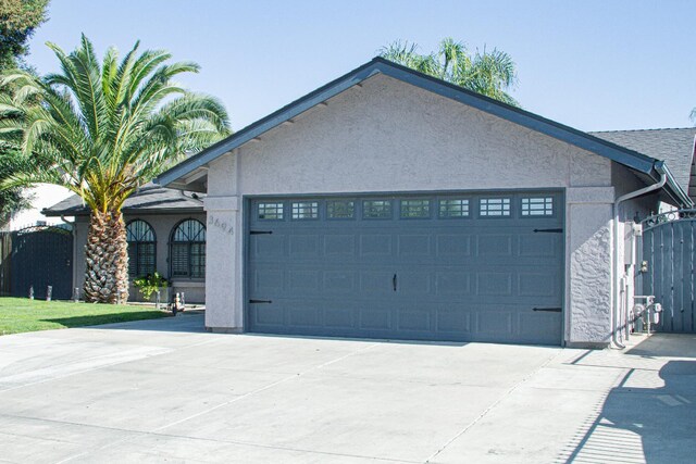 3694 W Robinson Ave, Fresno, CA 93722 - view of front facade featuring a garage, stucco siding, and driveway