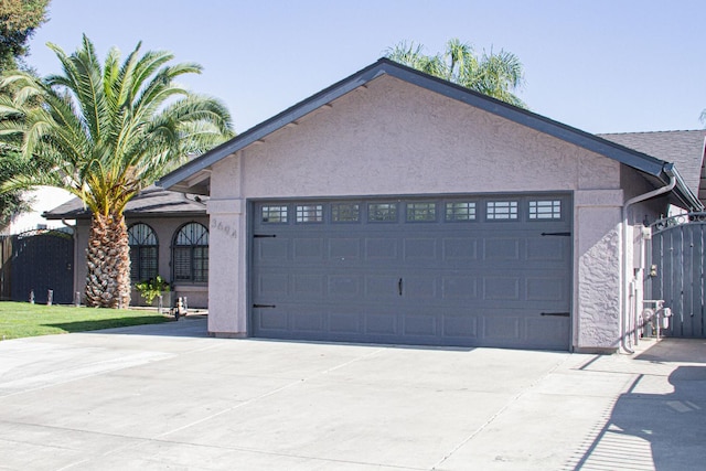 3694 W Robinson Ave, Fresno, CA 93722 - view of front of property featuring an attached garage, concrete driveway, and stucco siding