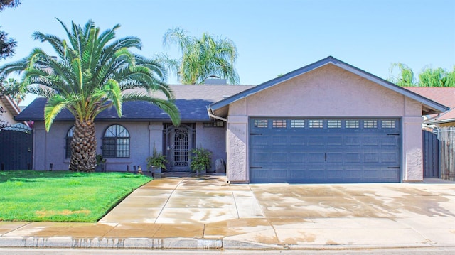 3694 W Robinson Ave, Fresno, CA 93722 - view of front of property featuring stucco siding, an attached garage, and driveway