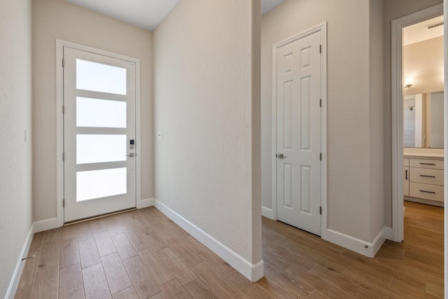 entryway featuring light wood-style floors and baseboards