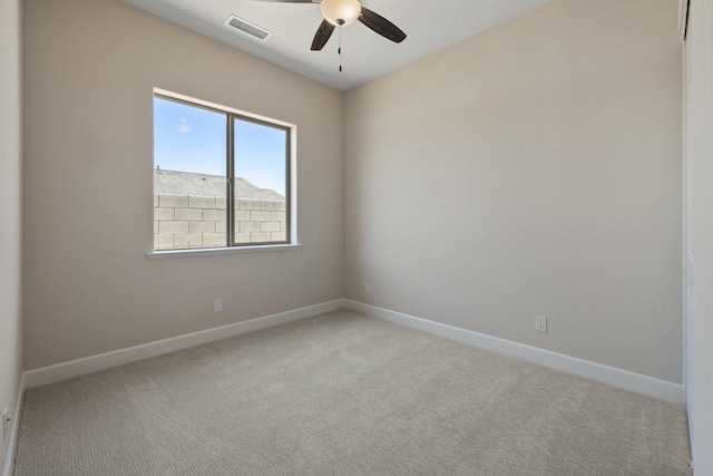 carpeted empty room with a ceiling fan and baseboards