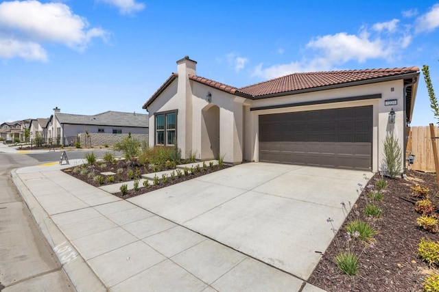 mediterranean / spanish home with a chimney, a tiled roof, and stucco siding