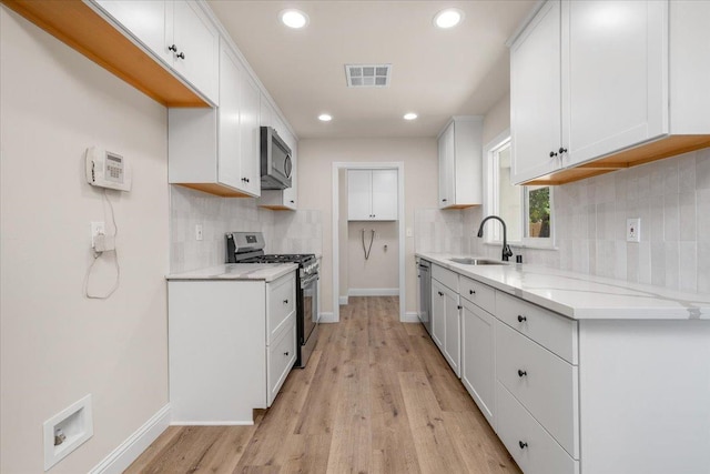 5706 N Tamera Ave, Fresno, CA 93711 - kitchen with appliances with stainless steel finishes, a sink, tasteful backsplash, baseboards, and recessed lighting
