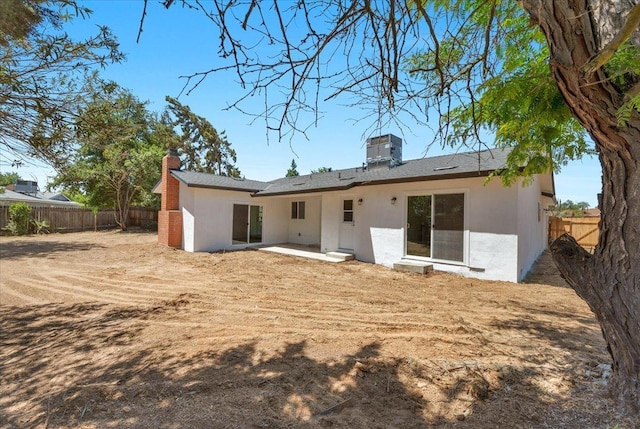 5706 N Tamera Ave, Fresno, CA 93711 - back of property with stucco siding, a fenced backyard, a chimney, a patio area, and central AC