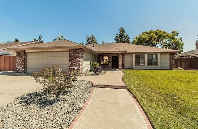 1025 E Cambridge Ave, Visalia, CA 93292 - ranch-style home featuring brick siding, a garage, and concrete driveway