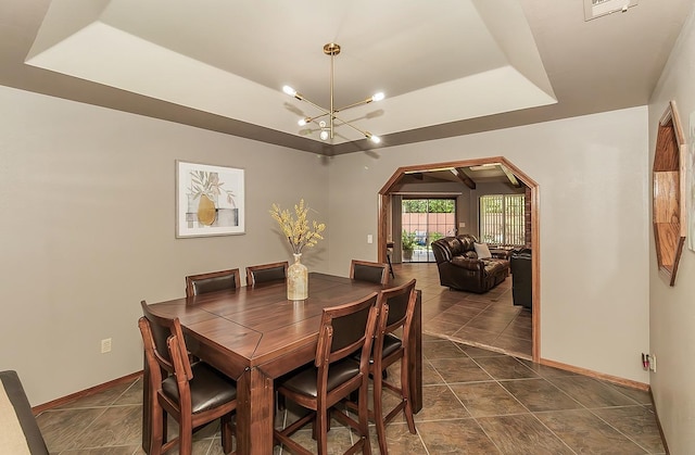 1025 E Cambridge Ave, Visalia, CA 93292 - dining space with a raised ceiling, a chandelier, baseboards, and arched walkways