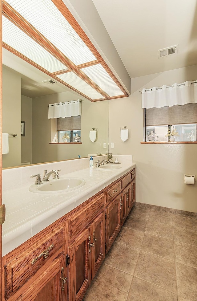 1025 E Cambridge Ave, Visalia, CA 93292 - full bath with tile patterned flooring and double vanity