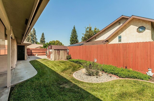 1025 E Cambridge Ave, Visalia, CA 93292 - view of yard with a storage unit, an outbuilding, and a patio
