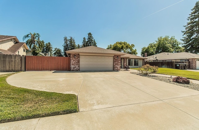 1025 E Cambridge Ave, Visalia, CA 93292 - view of front facade with a garage, brick siding, and driveway