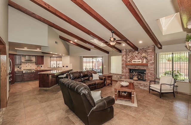 1025 E Cambridge Ave, Visalia, CA 93292 - living room with a skylight, ceiling fan, beamed ceiling, light tile patterned floors, and a fireplace