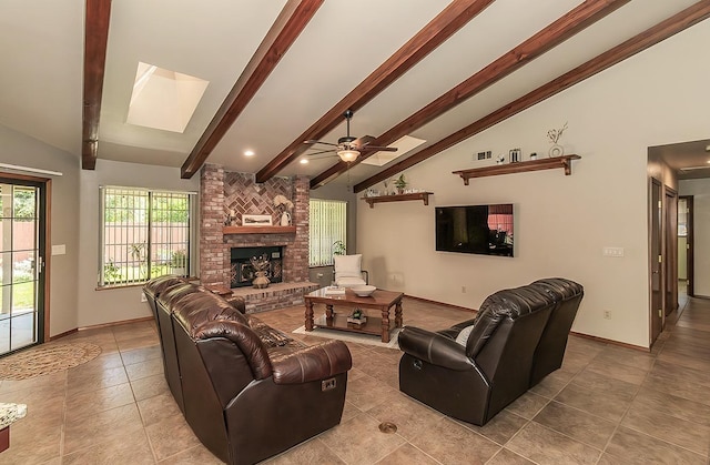 1025 E Cambridge Ave, Visalia, CA 93292 - living room featuring a skylight, a fireplace, baseboards, tile patterned floors, and ceiling fan