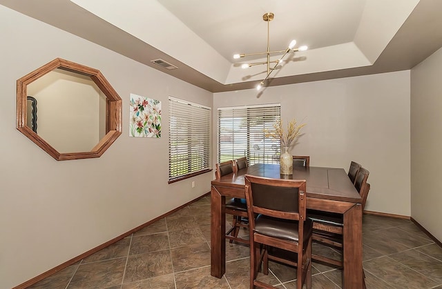 1025 E Cambridge Ave, Visalia, CA 93292 - dining space with a tray ceiling, a chandelier, and baseboards