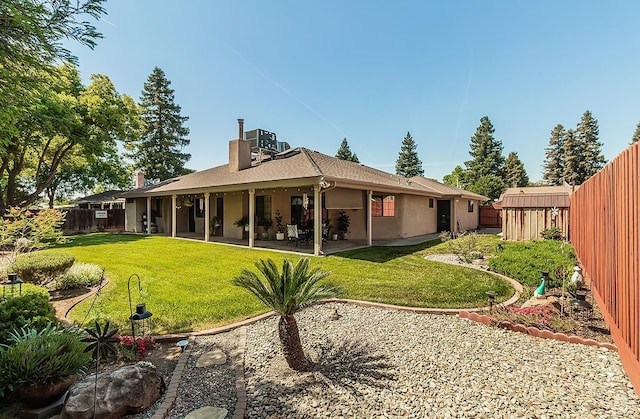 1025 E Cambridge Ave, Visalia, CA 93292 - back of property with a chimney, a patio, central AC, and stucco siding