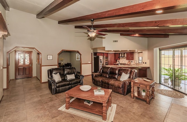 1025 E Cambridge Ave, Visalia, CA 93292 - living area with ceiling fan, light tile patterned floors, arched walkways, and baseboards