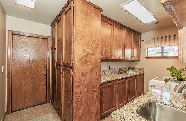 1025 E Cambridge Ave, Visalia, CA 93292 - kitchen featuring a sink and light stone counters