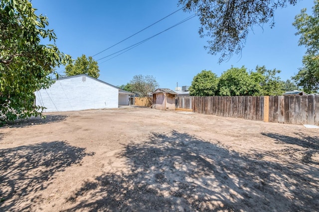 153 Birch, Fresno, CA 93650 - view of yard with fence, a storage unit, and an outbuilding